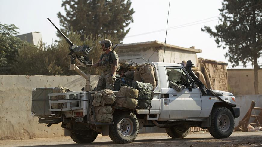 U.S soldiers ride a military vehicle in al-Kherbeh village, northern Aleppo province, Syria October 24, 2016. REUTERS/Khalil Ashawi - S1AEUIVBKLAA
