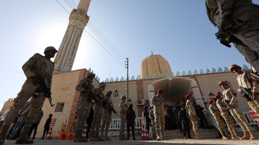 Military secure worshippers outside Al Rawdah mosque during the first Friday prayer after attack in Bir Al-Abed, Egypt, December 1, 2017. REUTERS/Mohamed Abd El Ghany - RC16F7B44310