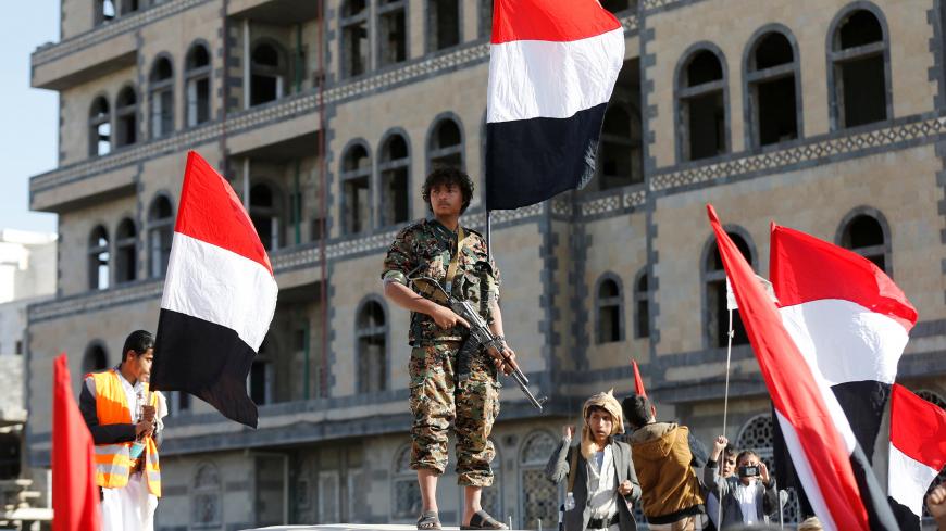 A Houthi militant stands guard during a rally to celebrate the killing of Yemen's former president Ali Abdullah Saleh in Sanaa, Yemen - RC1479B53230