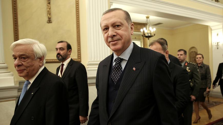 Greek President Prokopis Pavlopoulos (L) and his Turkish counterpart Recep Tayyip Erdogan (R) enter the Presidential Mansion during a meeting in Athens, Greece December 7, 2017. REUTERS/Simela Pantzartzi/Pool - RC1B07EB44A0