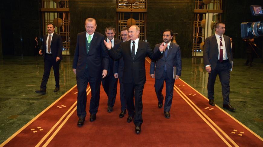 Russian President Vladimir Putin (C, front) and Turkish President Tayyip Erdogan (L, front) walk during a meeting in Ankara, Turkey December 11, 2017. Sputnik/Alexei Druzhinin/Sputnik via REUTERS ATTENTION EDITORS - THIS IMAGE WAS PROVIDED BY A THIRD PARTY. - UP1EDCB1EWG4D