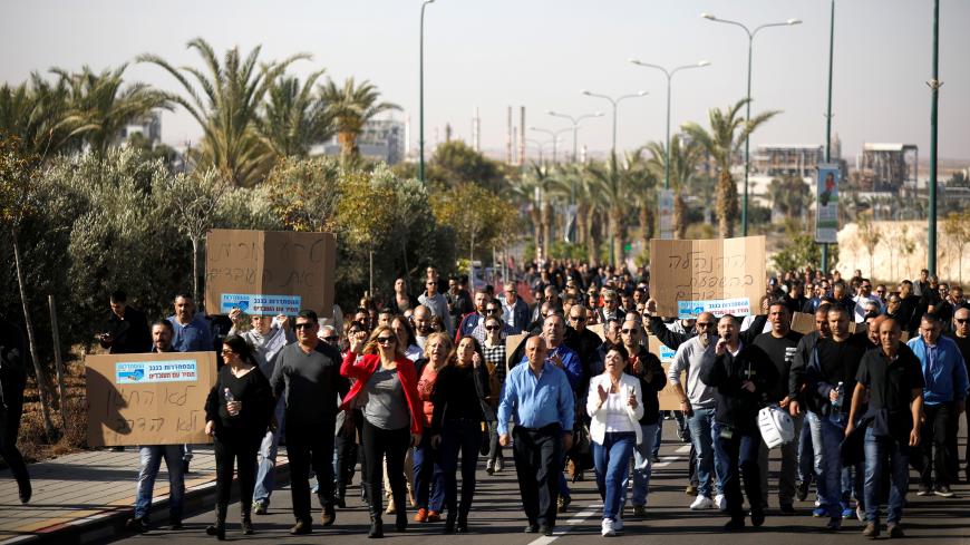 REFILE - CORRECTING DATE Worker of Teva Pharmaceutical Industries walk on a road as they block it during a demonstration near the facility in Neot Hovav, southern Israel December 17, 2017. REUTERS/Amir Cohen - RC1741A59B90
