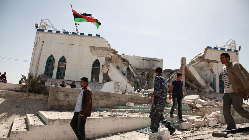 People inspect the damage done to a Sufi shrine, the tomb of Sidi Mohamed Landoulsi, after an explosion in the Tajoura neighbourhood on the outskirts of Tripoli, March 28, 2013. An explosion damaged the shrine early in the morning on Thursday, according to a witness. REUTERS/Stringer (LIBYA - Tags: POLITICS CIVIL UNREST RELIGION) - GM1E93S1S7K01
