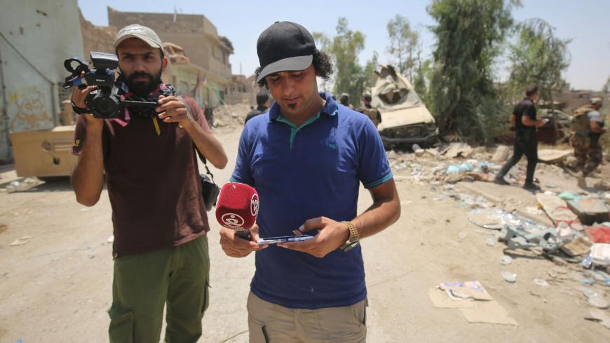 Iraqi journalists are seen covering events in the embattled city of Mosul on June 20, 2017, during the ongoing offensive by Iraqi forces to retake the last district of the city still held by the Islamic State group.
The death of two journalists in Mosul has highlighted once more the particular dangers of covering the battle to recapture the Iraqi city from Islamic State group fighters. Covering the battle for Mosul, especially in the narrow streets of the Old City, where the last jihadists are holed up, is