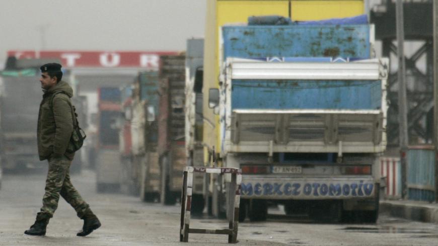 A soldier walks at Ibrahim Khalil border gate between Iraq and Turkey, near Zakhu, February 26, 2008. Turkish products dominate shop shelves in Iraq's Kurdish north. So, even as residents here seethe in anger at Turkey's big military incursion into their homeland, they cannot afford to cut the economic lifeline with their larger neighbour. Picture taken February 26, 2008.    To match feature IRAQ-TURKEY/TRADE     REUTERS/Ceerwan Aziz (IRAQ) - GM1E42R1FKC01