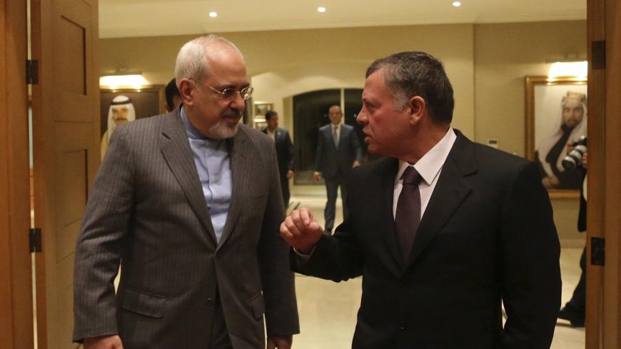 Jordan's King Abdullah (R) walks with Iranian Foreign Minister Mohammad Javad Zarif befor their meeting at the Royal Palace in Amman January 14, 2014 REUTERS/Jordanian Royal Palace/Yousef Allan/Handout via Reuters (JORDAN - Tags: POLITICS ROYALS) ATTENTION EDITORS - THIS IMAGE WAS PROVIDED BY A THIRD PARTY. FOR EDITORIAL USE ONLY. NOT FOR SALE FOR MARKETING OR ADVERTISING CAMPAIGNS. THIS PICTURE IS DISTRIBUTED EXACTLY AS RECEIVED BY REUTERS, AS A SERVICE TO CLIENTS - GM1EA1F08CI01