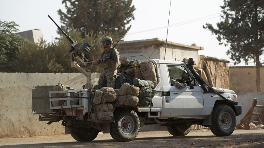 U.S soldiers ride a military vehicle in al-Kherbeh village, northern Aleppo province, Syria October 24, 2016. REUTERS/Khalil Ashawi - S1AEUIVBKLAA