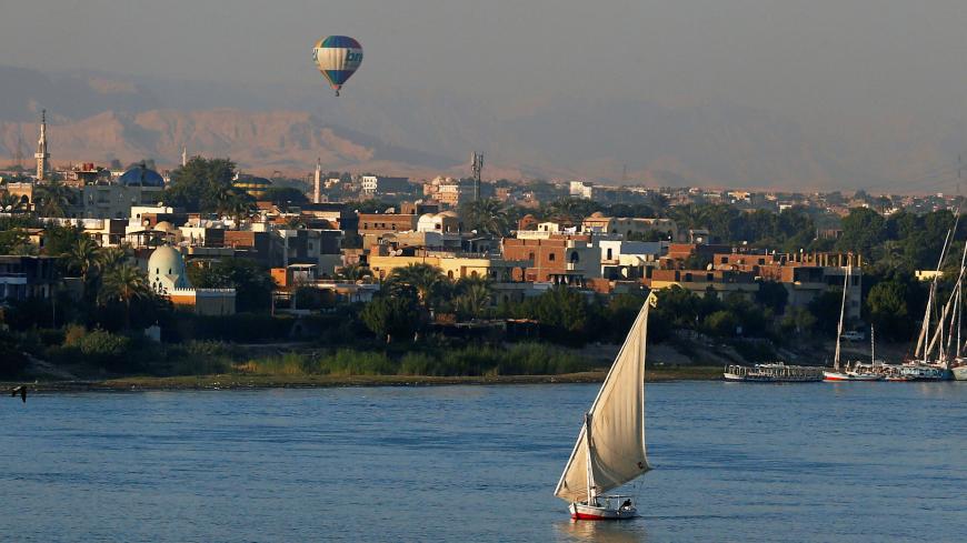 A balloon is seen above the Nile River as boats wait for tourists in the port city of Luxor, south of Cairo, Egypt December 14, 2016. Picture taken December 14, 2016. REUTERS/Amr Abdallah Dalsh - RC155D167990