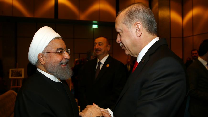 Turkish President Tayyip Erdogan meets with Iran's President Hassan Rouhani during an extraordinary meeting of the Organisation of Islamic Cooperation (OIC) in Istanbul, Turkey, December 13, 2017. REUTERS/Kayhan Ozer/Pool - RC1507ABA930