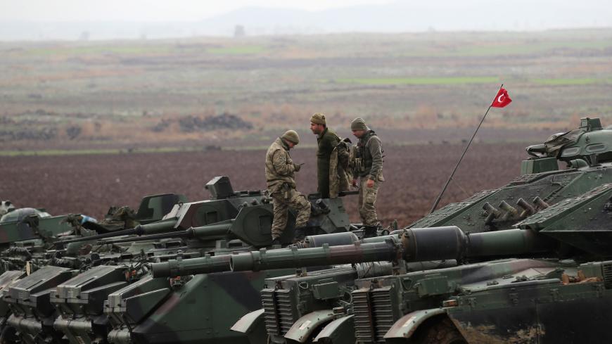 Turkish army tanks and armoured personnel carriers (APC) are seen near the Turkish-Syrian border in Hatay province, Turkey January 23, 2018. REUTERS/Umit Bektas - RC1FA0C88540