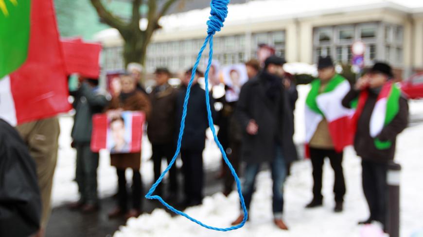 Iranian exiles shout slogans in front of a mock gallows to protest against executions in Iran during a demonstration outside the Iranian embassy in Brussels December 29, 2010.   REUTERS/Francois Lenoir (BELGIUM - Tags: CIVIL UNREST POLITICS) - GM1E6CT1T7M01