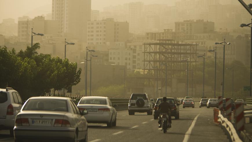 EDITORS' NOTE: Reuters and other foreign media are subject to Iranian restrictions on their ability to film or take pictures in Tehran.
Motorists travel on a highway in Tehran as the city is covered in dust July 6, 2009. The government closed private educational centres, state offices, industrial units and military bases for two days and raised its pollution alert status due to the dust, which an official from Tehran's environment office attributed the source to dust from dried marshland in Iraq blown towar