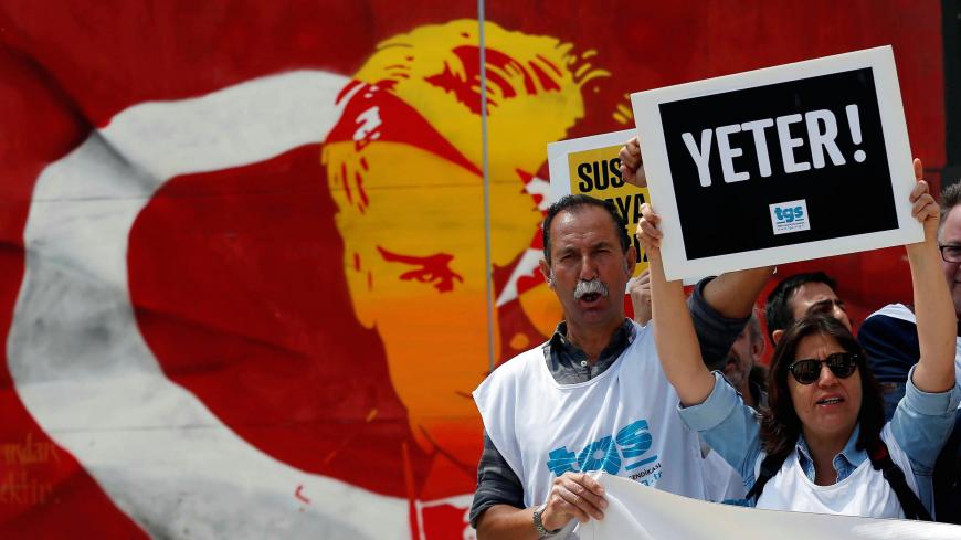Members of the Journalists Union of Turkey (TGS) shout slogans during a demonstration to mark World Press Freedom Day in central Istanbul, Turkey May 3, 2017. The placard reads: "Enough!" REUTERS/Murad Sezer - RC12B0374FE0