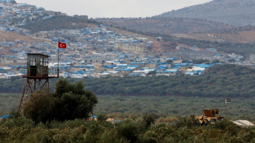 A Turkish military armoured vehicle guards on the border line located opposite the Syrian town of Atimah, Idlib province, in this picture taken from Reyhanli, Hatay province, Turkey October 10, 2017. REUTERS/Osman Orsal - RC117E0C0980