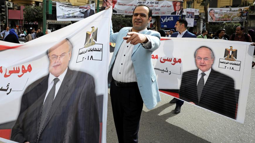 Egyptian supporters of presidential candidate Moussa Mostafa Moussa carry election campaign banners during a march in Cairo, Egypt March 4, 2018.  REUTERS/Mohamed Abd El Ghany - RC17ED8A0400