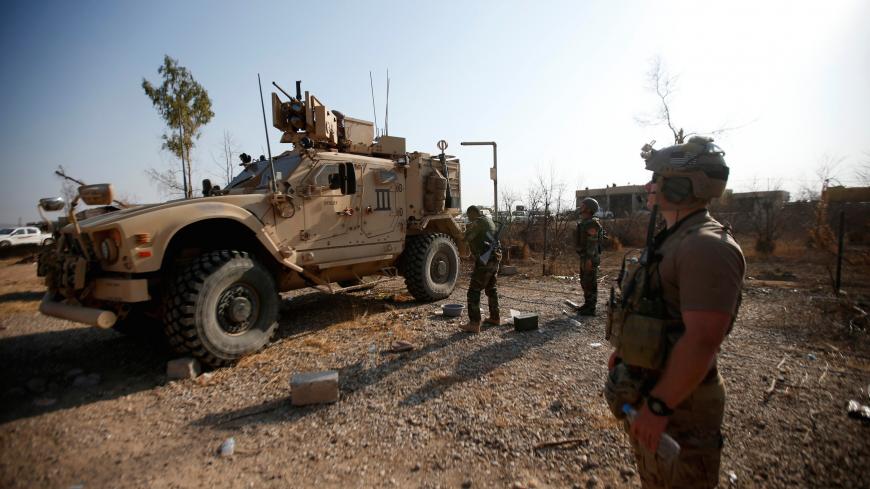U.S. military vehicles are seen in the town of Bashiqa, east of Mosul, during an operation to attack Islamic State militants in Mosul, Iraq, November 7, 2016. REUTERS/Azad Lashkari - S1AEULMKDCAB