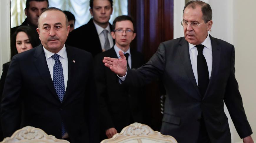 Russian Foreign Minister Sergei Lavrov shows the way to his Turkish counterpart Mevlut Cavusoglu during a meeting in Moscow, Russia, December 20, 2016. REUTERS/Pavel Golovkin/Pool - RC1A9217F4F0
