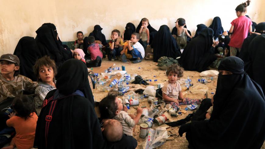 Families and relatives of Islamic State militants are see after they surrender themselves to the Kurdish Peshmerga forces in al-Ayadiya, northwest of Tal Afar, Iraq August 30, 2017. REUTERS/Ari Jalal - RC1763B750C0