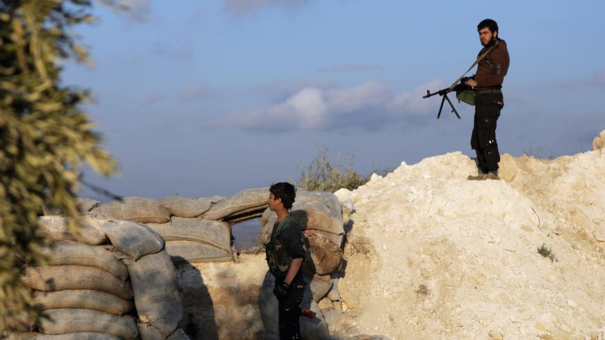 Turkish-backed Free Syrian Army fighter stands near stacked sandbags in Eastern Afrin, Syria, February 13, 2018. REUTERS/Khalil Ashawi - RC1A6D3C0CA0