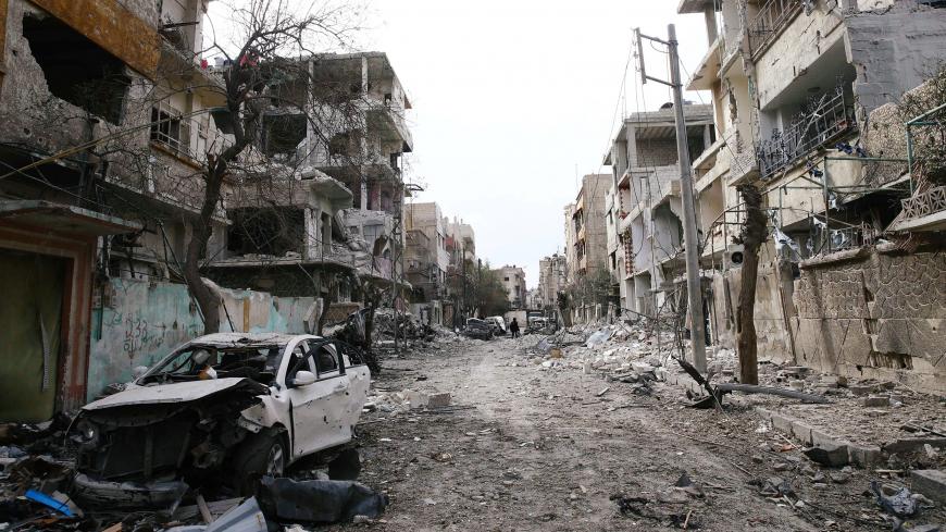 Damaged cars and buildings are seen in the besieged town of Douma, Eastern Ghouta, Damascus, Syria February 25, 2018. REUTERS/Bassam Khabieh - RC1683B91A30