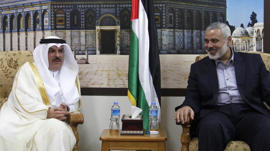 Head of the Hamas government in the Gaza Strip, Ismail Haniya (R), meets with the head of a Qatari delegation Mohammed al-Emadi in Gaza City on September 25, 2012, where a number of projects included in the Qatari grant for the reconstruction of Gaza are expected to be launched. AFP PHOTO/MOHAMMED ABED        (Photo credit should read MOHAMMED ABED/AFP/GettyImages)