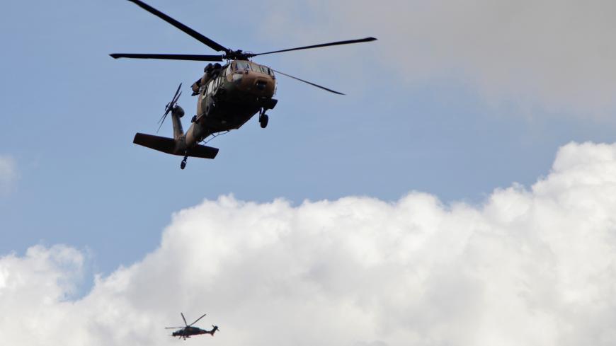 A picture taken on March 2, 2018 shows a Turkish army Black Hawk helicopter (front) and a T129 ATAK attack helicopter flying towards the village of Al-Maabatli in the Afrin region in the northwestern Aleppo province countryside as part of the ongoing offensive. / AFP PHOTO / Bakr ALKASEM        (Photo credit should read BAKR ALKASEM/AFP/Getty Images)