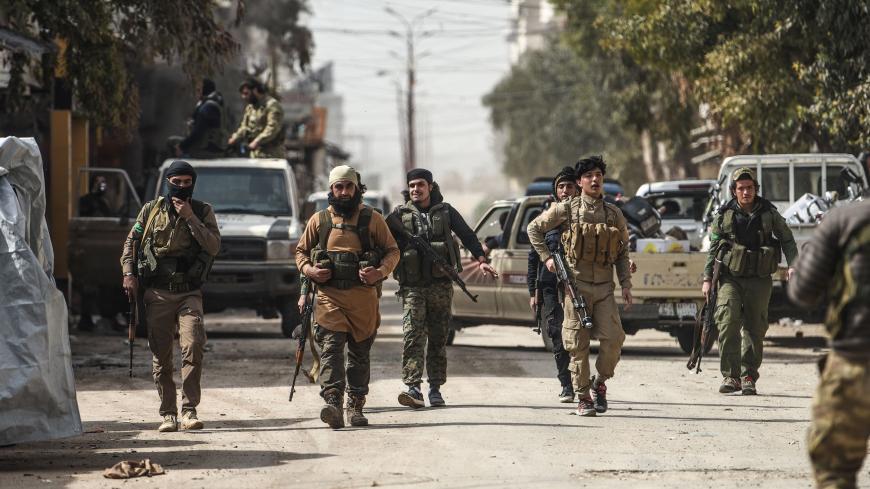 Turkish-backed Syrian Arab fighters walk in the streets after seizing control of the northwestern Syrian city of Afrin from the Kurdish People's Protection Units (YPG) on March 18, 2018.
In a major victory for Ankara's two-month operation against the Kurdish People's Protection Units (YPG) in northern Syria, Turkish-led forces pushed into Afrin apparently unopposed, taking up positions across the city. / AFP PHOTO / BULENT KILIC (Photo credit should read BULENT KILIC/AFP/Getty Images)
