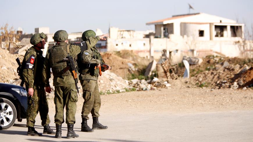 Russian solders are seen at a new corridor of Jisreen-Mleha road where they expect people to arrive from eastern Ghouta, in Damascus, Syria March 8, 2018. REUTERS/Omar Sanadiki - RC1D320A0E90