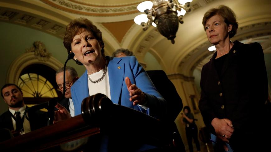 Senator Jeanne Shaheen (D-NH), accompanied by Senator Tammy Baldwin (D-WI), speaks with reporters following the party luncheons on Capitol Hill in Washington, U.S. December 5, 2017. REUTERS/Aaron P. Bernstein - RC1567898790