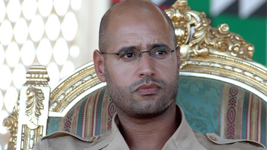 The son of Libyan leader Moamer Kadhafi Saif al-Islam (R) sits with Libyan Prime Minister Baghdadi Mahmudi (not seen) as they attend a ceremony to mark the arrival of water from the Great Manmade River (GMR) in the southern Libyan city of Ghiryan, 18 August 2007. The Great Manmade River is a huge network of pipes supplying water from under the Sahara desert to various cities and population centres in Libya. AFP PHOTO/ MAHMUD TURKIA (Photo credit should read MAHMUD TURKIA/AFP/Getty Images)