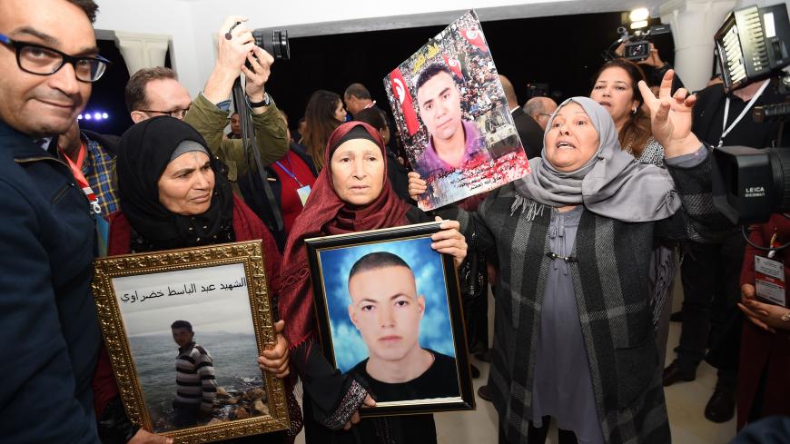 Tunisian mothers of a torture victims carry their sons' portraits as they arrive for a hearing before the The Truth and Dignity Commission (IVD) in Tunis on November 17, 2016.
Victims of murder, rape and torture under successive dictatorships started testifying on live television Thursday as Tunisia -- in a rare move for the Arab world -- tries to deal with decades of abuse.

The Truth and Dignity Commission (IVD) has tracked human rights violations committed between July 1955, a year before Tunisia gained 