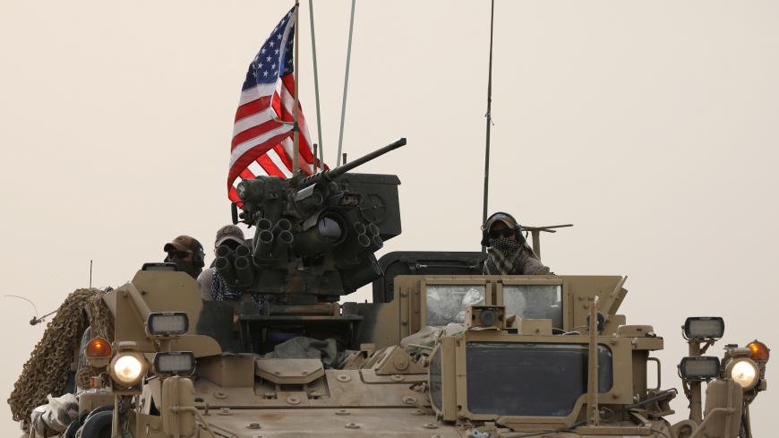 U.S forces on their military vehicle drive in the town of Darbasiya next to the Turkish border, Syria April 28, 2017. REUTERS/Rodi Said - RC16478B0600