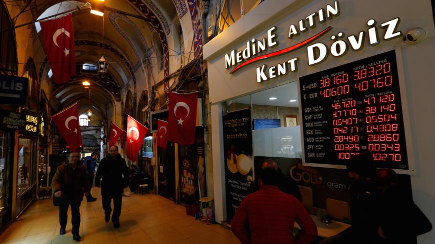 Merchants chat in front of a currency exchange office at the historical Grand Bazaar, known as the Covered Bazaar, in Istanbul, Turkey, January 12, 2017. Picture taken January 12, 2017. To match Insight TURKEY-ECONOMY/LIRA-RETAIL       REUTERS/Murad Sezer - RC144ADC54F0