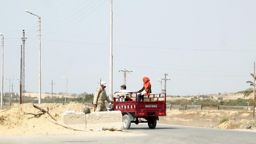 An army soldier is seen talking to locals at a check point between the northern Sinai cities of Al-Arish and Sheikh Zuwayed, May 25, 2015. Authorities in the Sinai Peninsula are battling insurgents who support Islamic State, the militant group that has seized parts of Iraq, Syria and Libya. The Sinai conflict, which has has displaced hundreds of Egyptians, is the biggest security challenge for President Abdel Fattah al-Sisi, who has promised to deliver stability after four years of turmoil triggered by the 