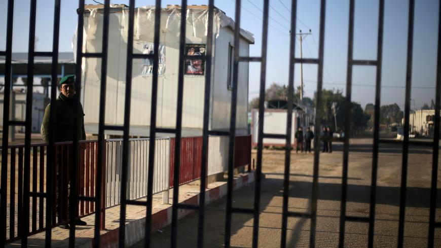 A Palestinian securityman stands outside Kerem Shalom, the main passage point for goods entering Gaza, after it was shut down by Israel, in the southern Gaza Strip January 14, 2018. REUTERS/Ibraheem Abu Mustafa - RC192449C1D0
