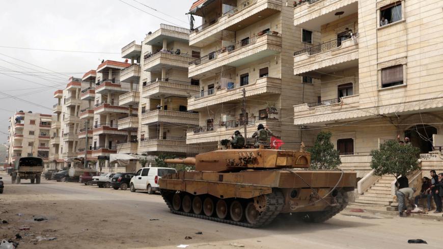 Turkish soldiers ride on a military vehicle in the center of Afrin, Syria March 24, 2018. REUTERS/Khalil Ashawi - RC1B6933DB00