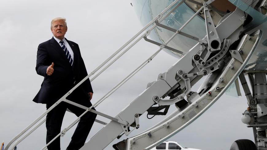U.S. President Donald Trump gives a thumbs up as he boards Air Force One upon departure from West Palm Beach, Florida, U.S., on his way back to Washington April 22, 2018. REUTERS/Kevin Lamarque - RC112A919C40
