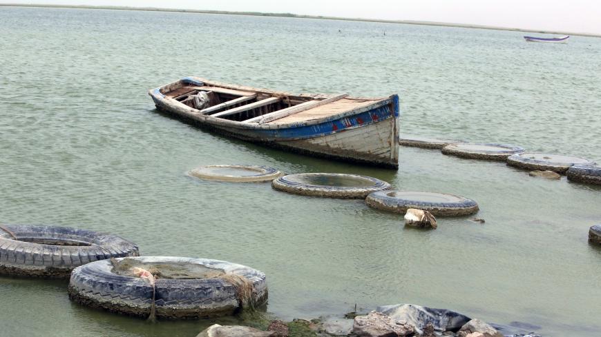 A fishing boat floats on the shores of the manmade Lake Razzaza, west of the Shiite Muslim holy city of Karbala, around 120 kilometres south of Baghdad, on May 20, 2013. For the past two weeks, most of fishermen who rely on their trade to make a living, have stopped sailing on the lake fearing that they might by targeted by gunmen coming from the mainly Sunni Muslim Anbar province where security has deteriorated. AFP PHOTO/AHMAD AL-RUBAYE        (Photo credit should read AHMAD AL-RUBAYE/AFP/Getty Images)