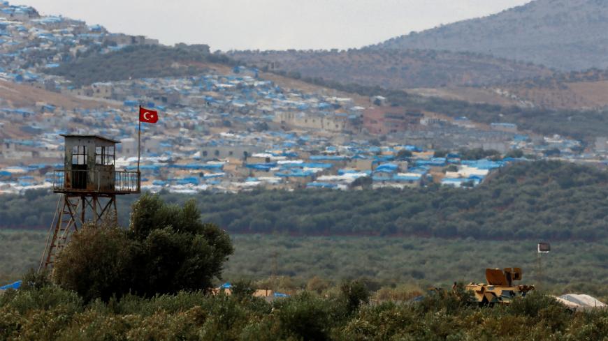 A Turkish military armoured vehicle guards on the border line located opposite the Syrian town of Atimah, Idlib province, in this picture taken from Reyhanli, Hatay province, Turkey October 10, 2017. REUTERS/Osman Orsal - RC117E0C0980