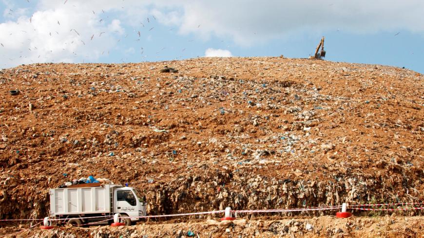 A truck transports trash at a garbage dump in Tripoli, northern Lebanon, November 2, 2017. Picture taken November 2, 2017. REUTERS/Omar Ibrahim - RC168D1B2FA0