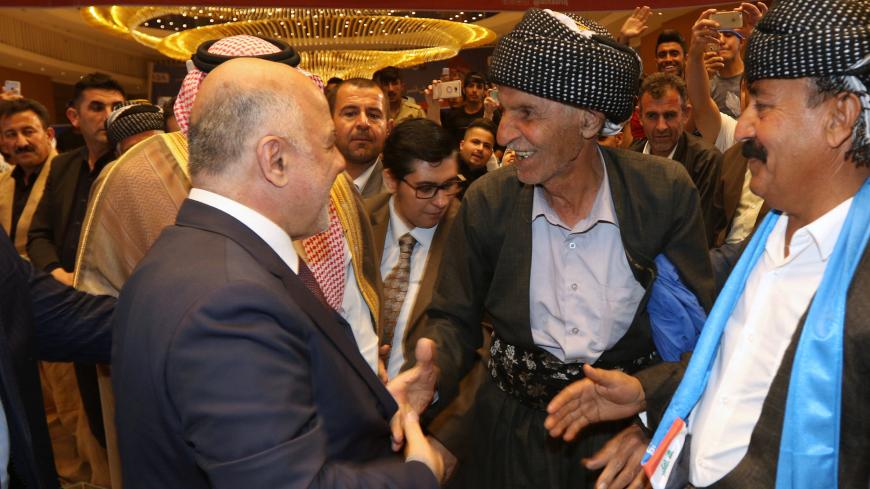 Iraqi Prime Minister Haidar al-Abadi shakes hands with his supporters during election campaign in Sulaimaniyah, Iraq April 25, 2018. Picture taken April 25, 2018. REUTERS/Ako Rasheed - RC19D5B12000