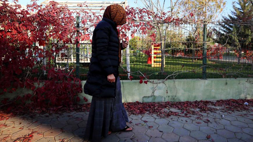 Haifa, a 36-year-old woman from Iraq's Yazidi community who was taken as a sex slave by Islamic State group fighters, stands on a street during an interview with AFP journalists in the northern Iraqi city of Dohuk on November 17, 2016.
Haifa and her family were among thousands of members of the Yazidi minority shown no mercy by IS when it swept through areas north and west of the Iraqi capital in 2014. As the extremists advanced, they was singled out for especially cruel persecution in a campaign of violenc