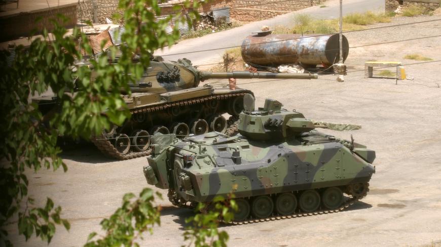 Turkish army tanks control the centre of the old medieval Kurdish town of Ammadiya, July 13. 2004. Turkish forces entered Iraq's Kurdish zone in 1997 under a year-long agreement with Kurdish authorities to pursue militants from a Turkish Kurd rebel group, but with their territory now part of a newly sovereign Iraq, Kurds feel the Turks may have overstayed their welcome. Picture taken July 13, 2004. REUTERS/Sasa Kralj  RCS/DBP - RP5DRICSWDAA