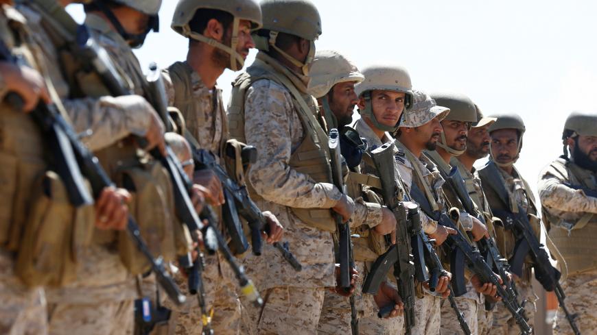 Saudi soldiers stand in line at an airfield where Saudi military cargo planes land to deliver aid in Marib, Yemen January 26, 2018. Picture taken January 26, 2018. REUTERS/Faisal Al Nasser - RC1D0C8D9D00