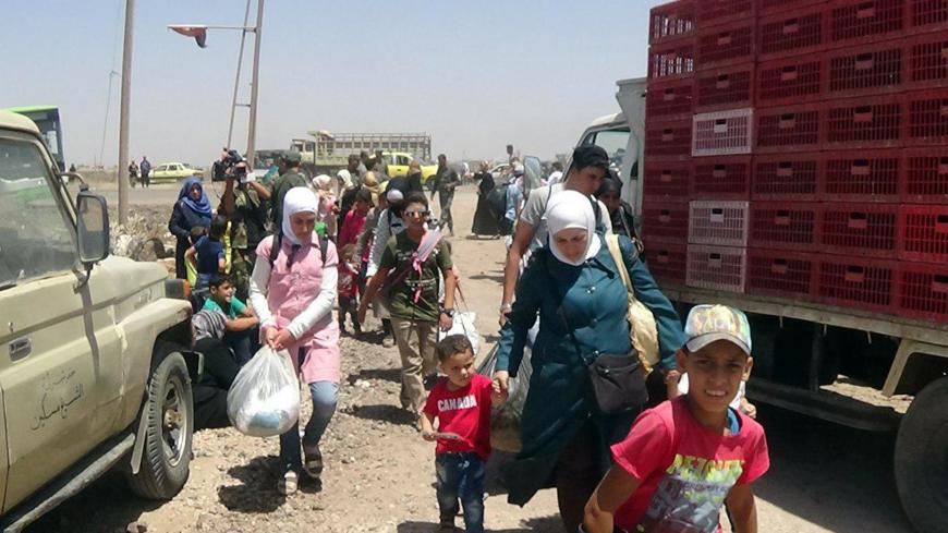 People walk as they hold their belongings in Deraa countryside, Syria in this handout released on June 28, 2018. SANA/Handout via REUTERS ATTENTION EDITORS - THIS PICTURE WAS PROVIDED BY A THIRD PARTY. REUTERS IS UNABLE TO INDEPENDENTLY VERIFY THE AUTHENTICITY, CONTENT, LOCATION OR DATE OF THIS IMAGE - RC1C2E612270