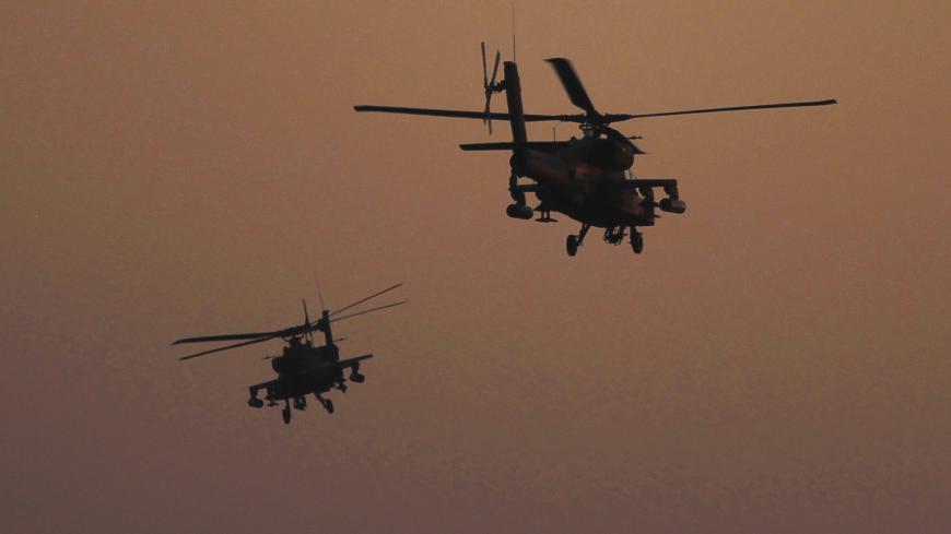 Apache helicopters fly over Tahrir Square during a protest to support the army, in Cairo July 26, 2013. Ousted Egyptian president Mohamed Mursi is under investigation for an array of charges including murder, the state news agency said on Friday, stoking tensions as opposing political camps took to the streets. Confirming the potential for bloodshed, two men were killed in confrontations in Egypt's second city Alexandria and a further 19 were hurt, Mena news agency reported. REUTERS/Amr Abdallah Dalsh (EGYP