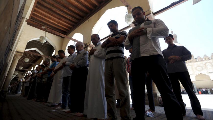 People attend the last Friday prayers of the holy month of Ramadan inside Al-Azhar mosque in the old Islamic area of Cairo, Egypt, July 10, 2015. REUTERS/Mohamed Abd El Ghany - GF10000154977