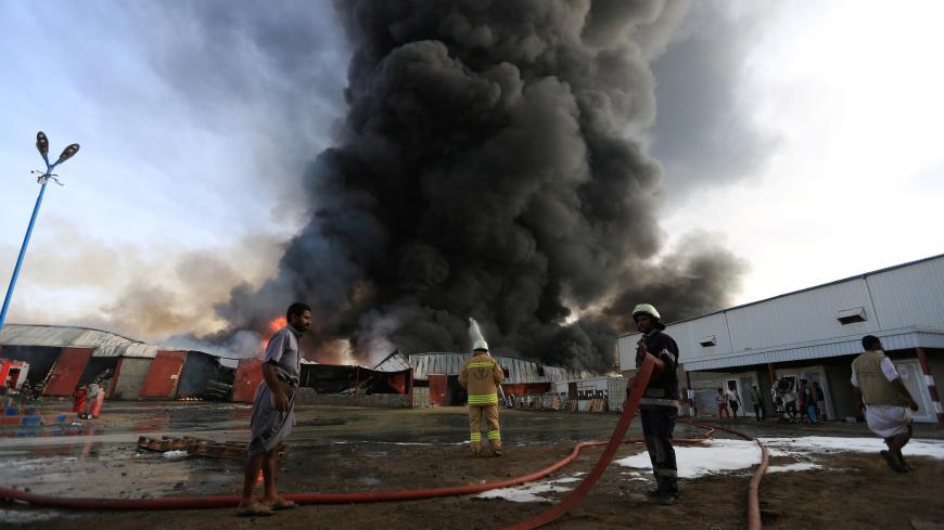 Firefighters try to extinguish a fire engulfing warehouse of the World Food Programme in Hodeida, Yemen March 31, 2018. REUTERS/Abduljabbar Zeyad - RC141A5A1C40