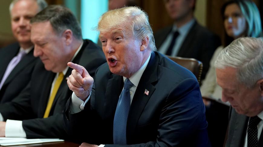 U.S. President Donald Trump speaks as he sits between U.S. Secretary of State Mike Pompeo and Secretary of Defense James Mattis during a cabinet meeting at the White House in Washington, U.S. June 21, 2018. REUTERS/Jonathan Ernst - RC14BFB2D4F0