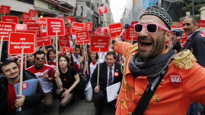 Activists hold banners during a HIV/AIDS awareness rally on World AIDS day in central Istanbul December 1, 2010. REUTERS/Murad Sezer (TURKEY - Tags: HEALTH SOCIETY IMAGES OF THE DAY) - GM1E6C11SKP01
